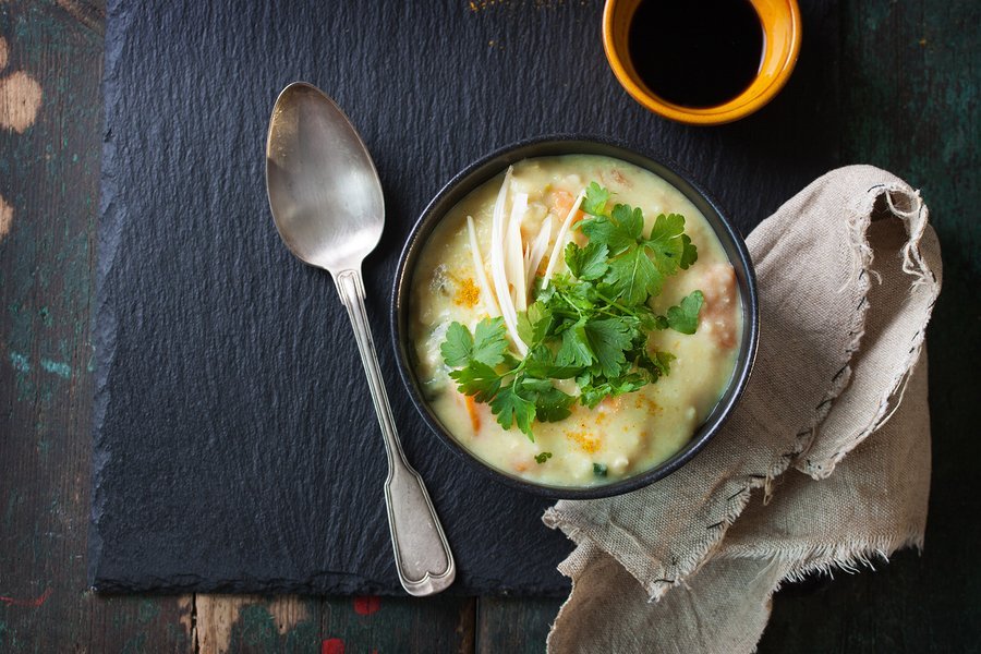 Tasty homemade curry soup with chicken and vegetables top view with copy space